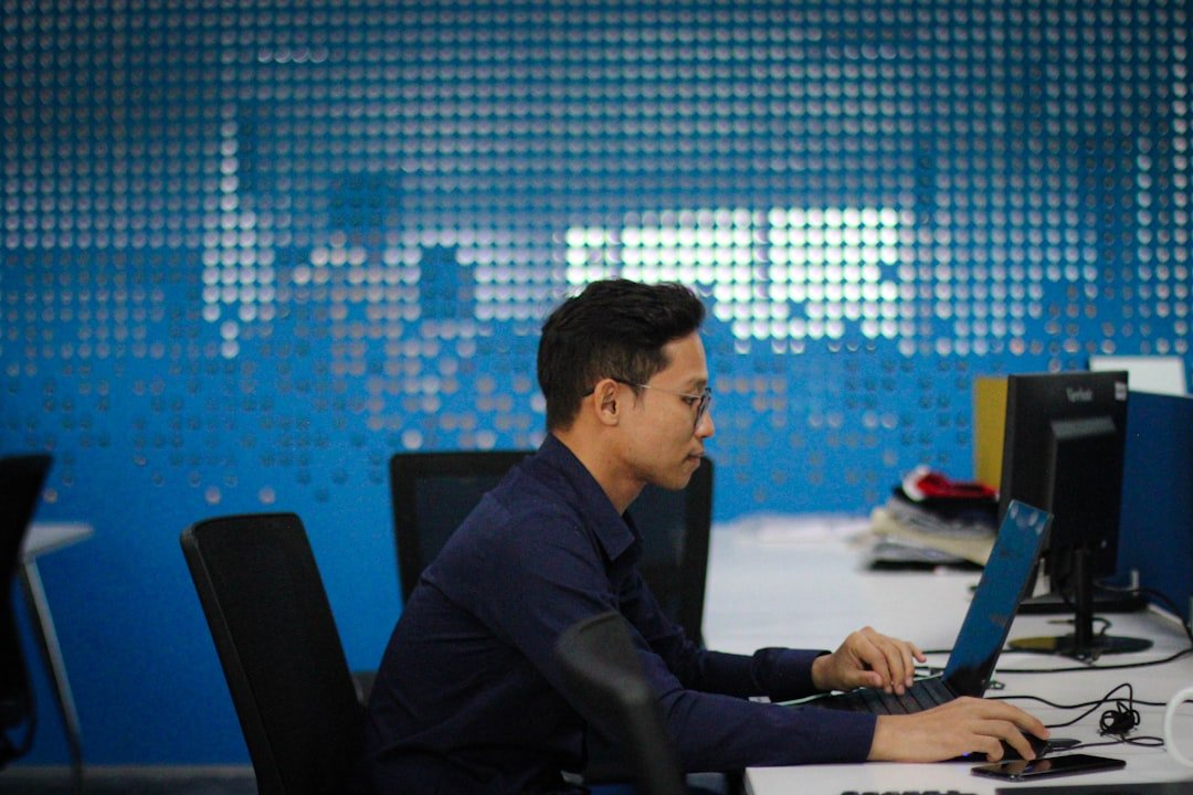 Professional working on a laptop in a modern office